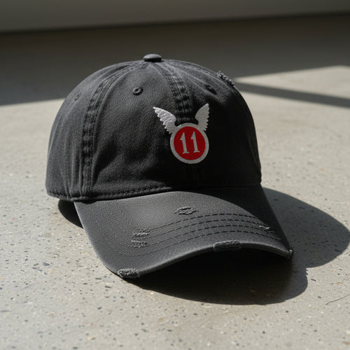black distressed dad hat with embroidered 11th airborne insignia