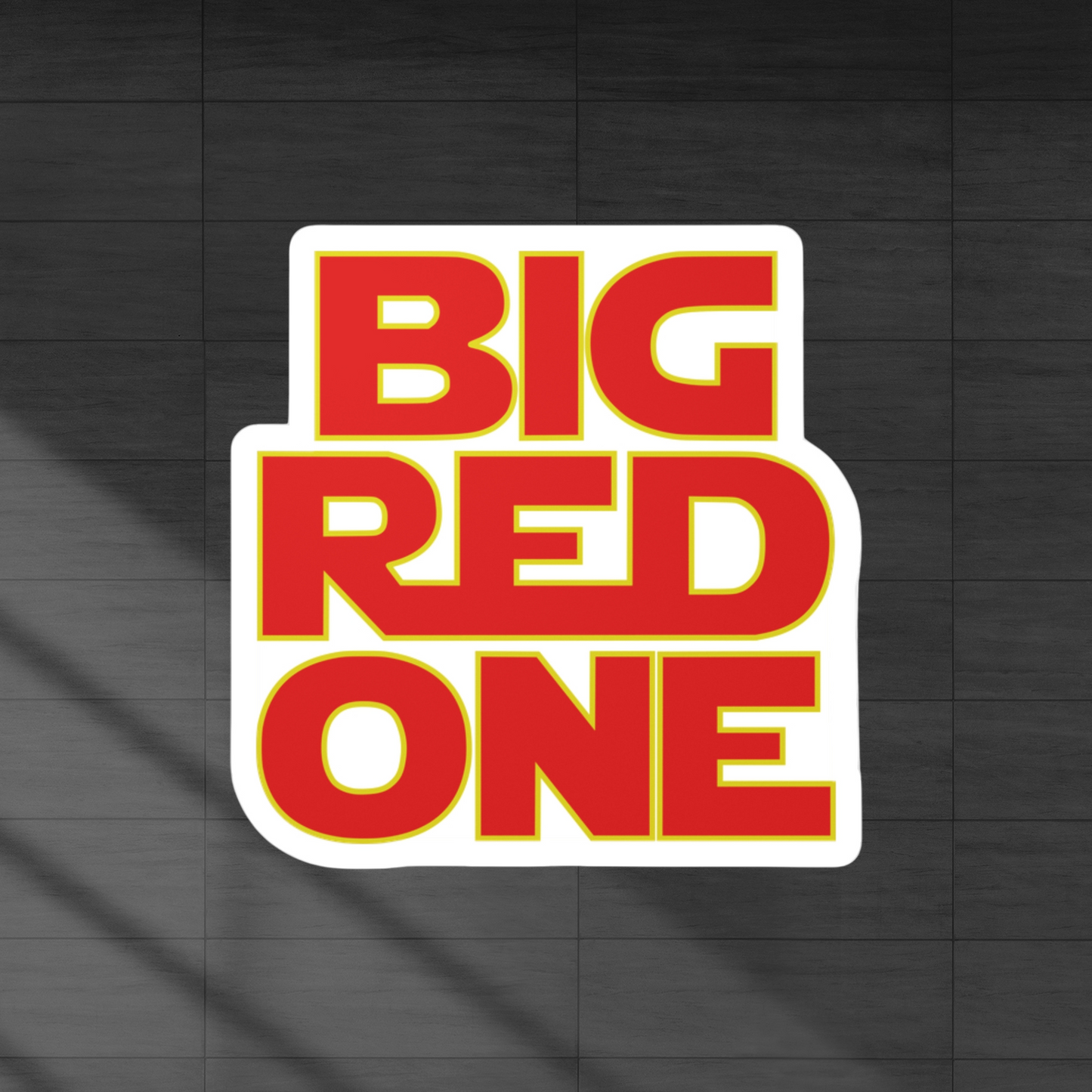 Decal sticker of the words big red one. Red color words with yellow border.