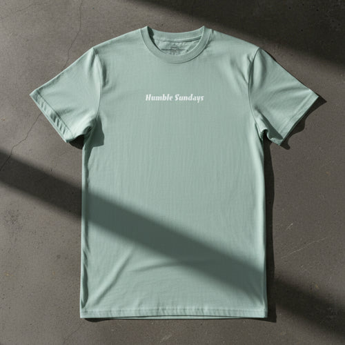 Men's agave colored t-shirt with the words Humble Sundays across the chest.