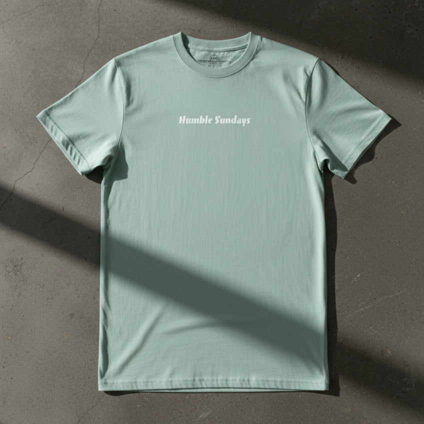 Men's agave colored t-shirt with the words Humble Sundays across the chest.