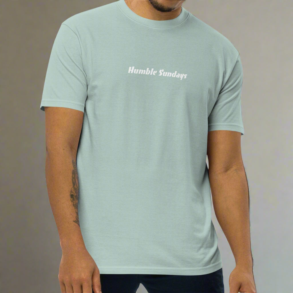 Man wearing a light blue t-shirt with the words humble sundays on the chest 