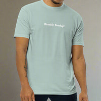 Man wearing a light blue t-shirt with the words humble sundays on the chest 