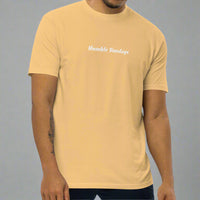 Man wearing a gold t-shirt with 'Humble Sundays' text