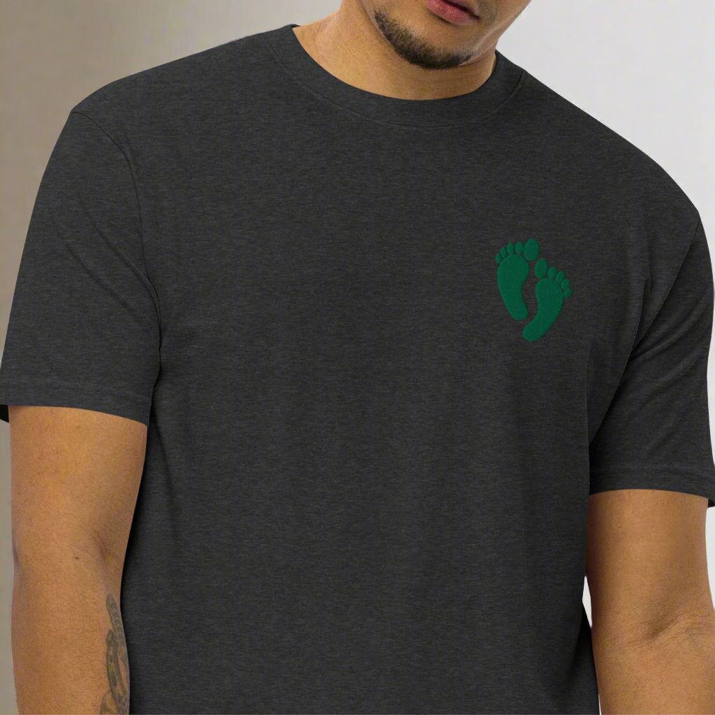 PJ green feet design embroidered into the lest chest of a t-shirt.