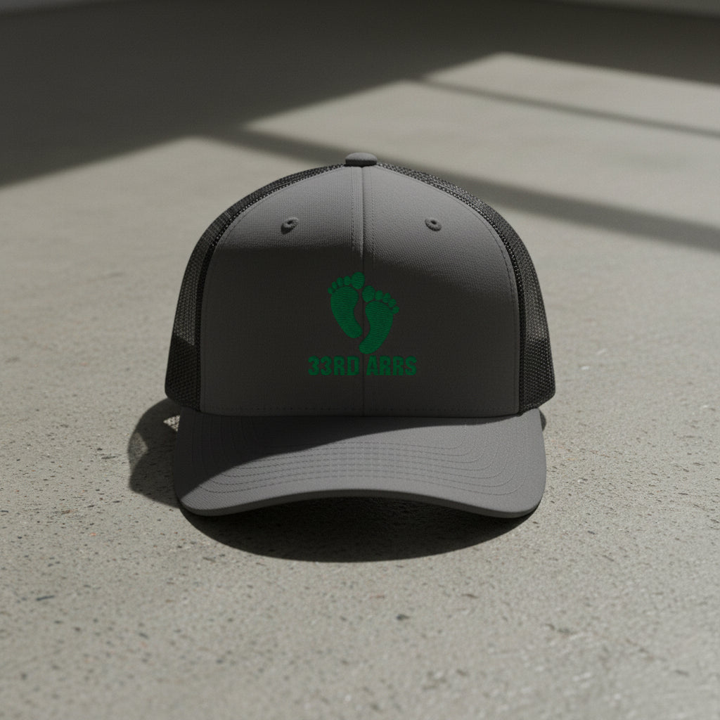 charcoal snapback trucker hat with air force pj green feet 33rd ARRS embroidered design