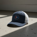 navy and white trucker hat with embroidered "250" inside a circle of stars for america 250th anniversary and 4th of july