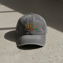 A distressed gray baseball cap with 'OEF' embroidered in gold on the front