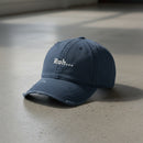navy distressed dad hat with embroidered text "Rah" 