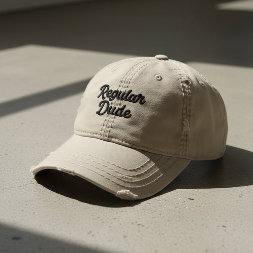 khaki distressed dad hat embroidered with the words regular dude