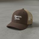 brown snapback cap with embroidered 'Regular Dude' text 