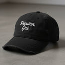 black distressed dad hat embroidered with the words regular gal
