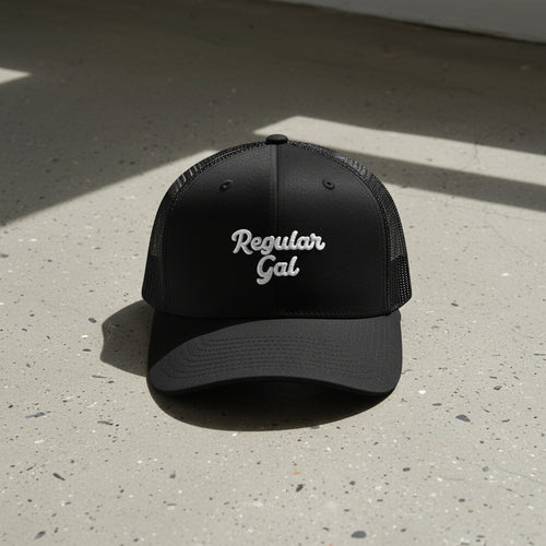 black snapback cap with embroidered 'Regular Gal' text 