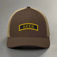 Beer tab modeled after ranger school tab, embroidered on a trucker hat.