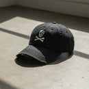 distressed dad hat with skull and crossbones logo