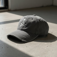 distressed dad hat with skull and crossbones logo