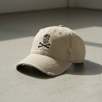 distressed dad hat with skull and crossbones logo