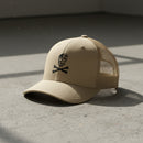 khaki snapback trucker hat with embroidered skull and crossbones 