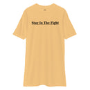 gold t-shirt with the text "stay in the fight" across the chest